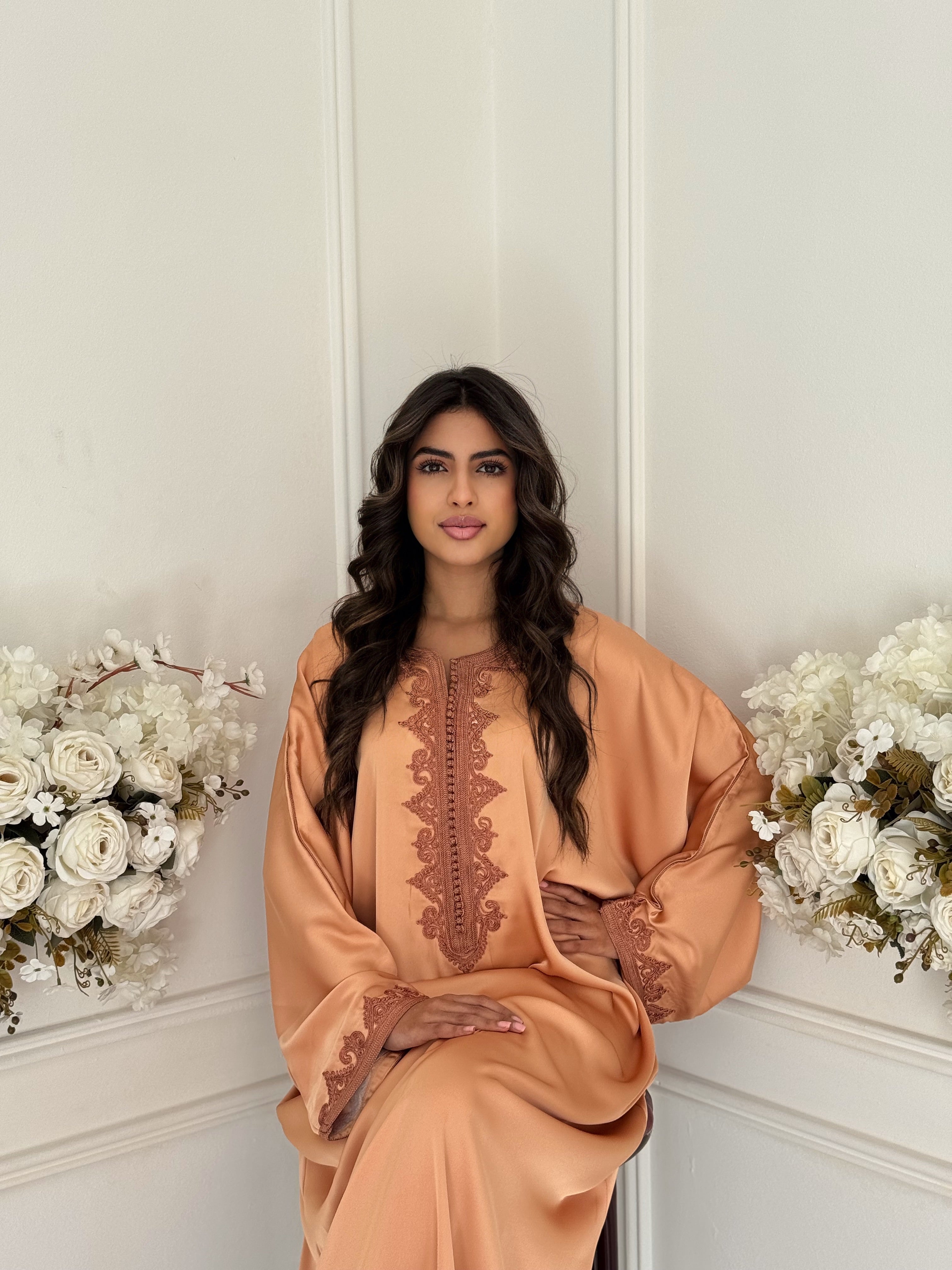 “Model wearing Gandoura Sara — peach drap de soie Moroccan gandoura with elegant oversized fit.”