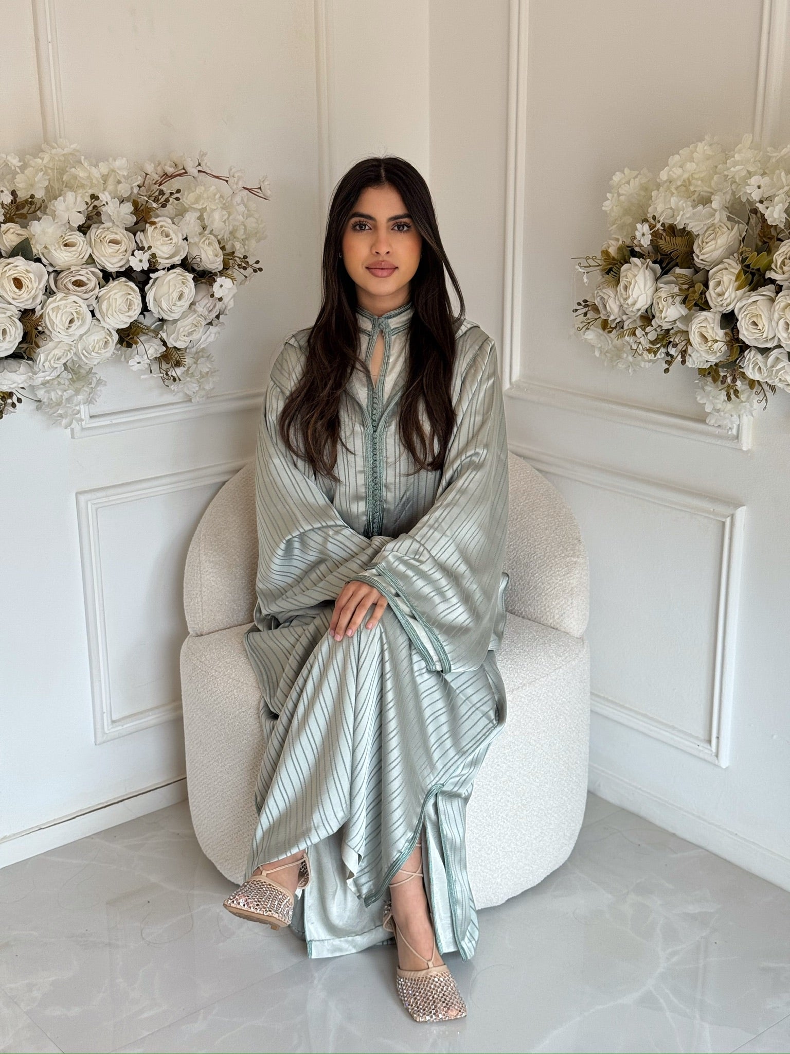 Woman wearing the Jellaba Sahar, an elegant Moroccan jellaba with wide sleeves, modest dress for Eid and special occasions.