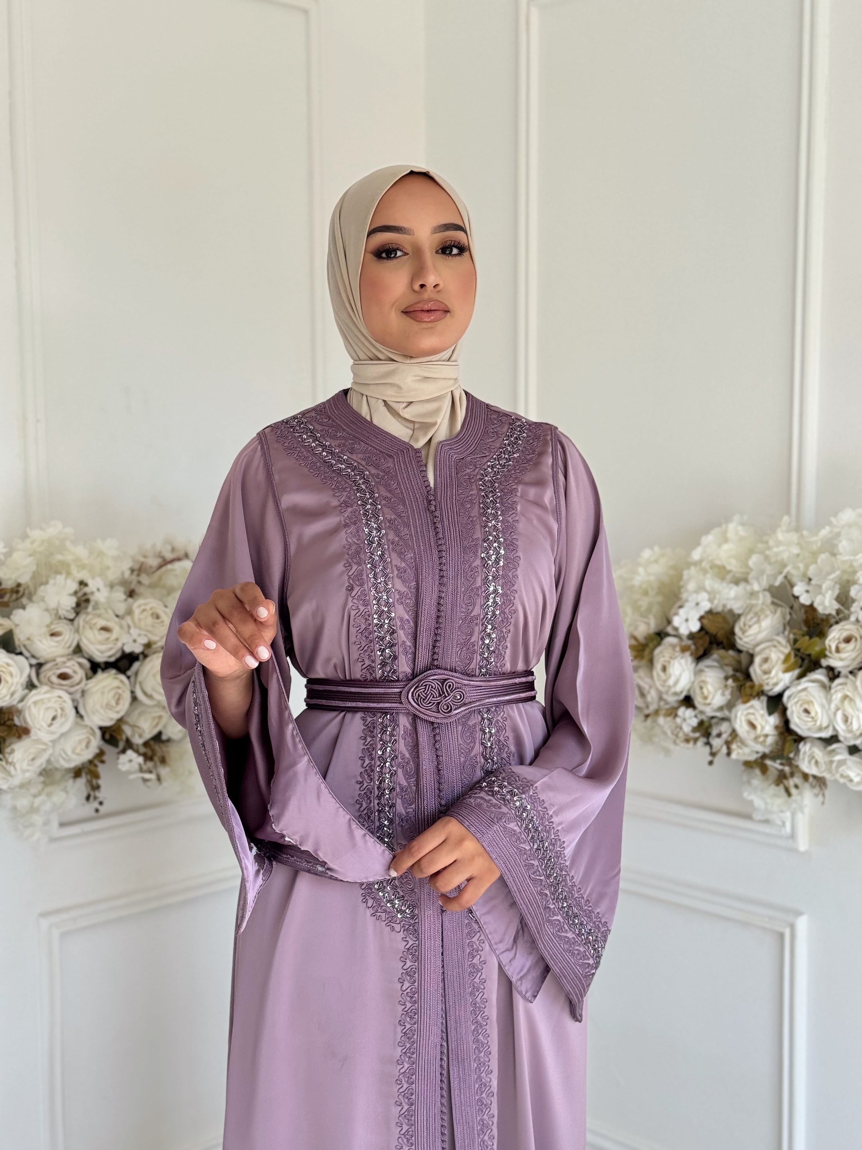 Model wearing Takchita Basma – lavender Moroccan takchita in luxurious drap de soie fabric.