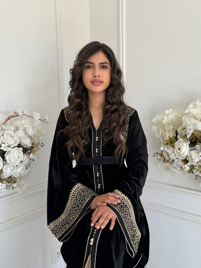 Model wearing Caftan Racha – black velvet Moroccan caftan with gold embroidery