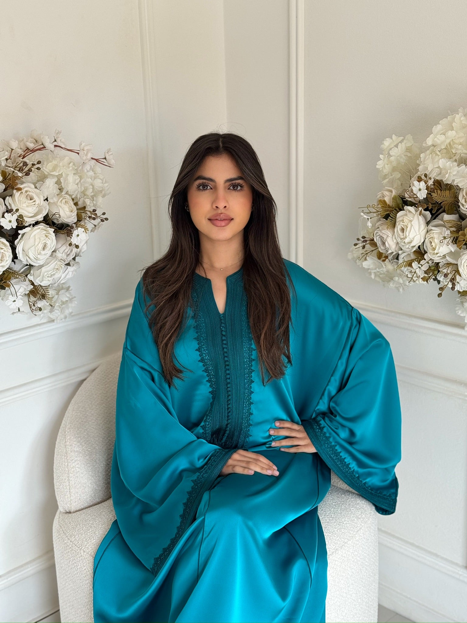 Woman wearing the Gandoura Mounia, an elegant Moroccan silk gandoura with wide sleeves, modest dress for Eid and special occasions.