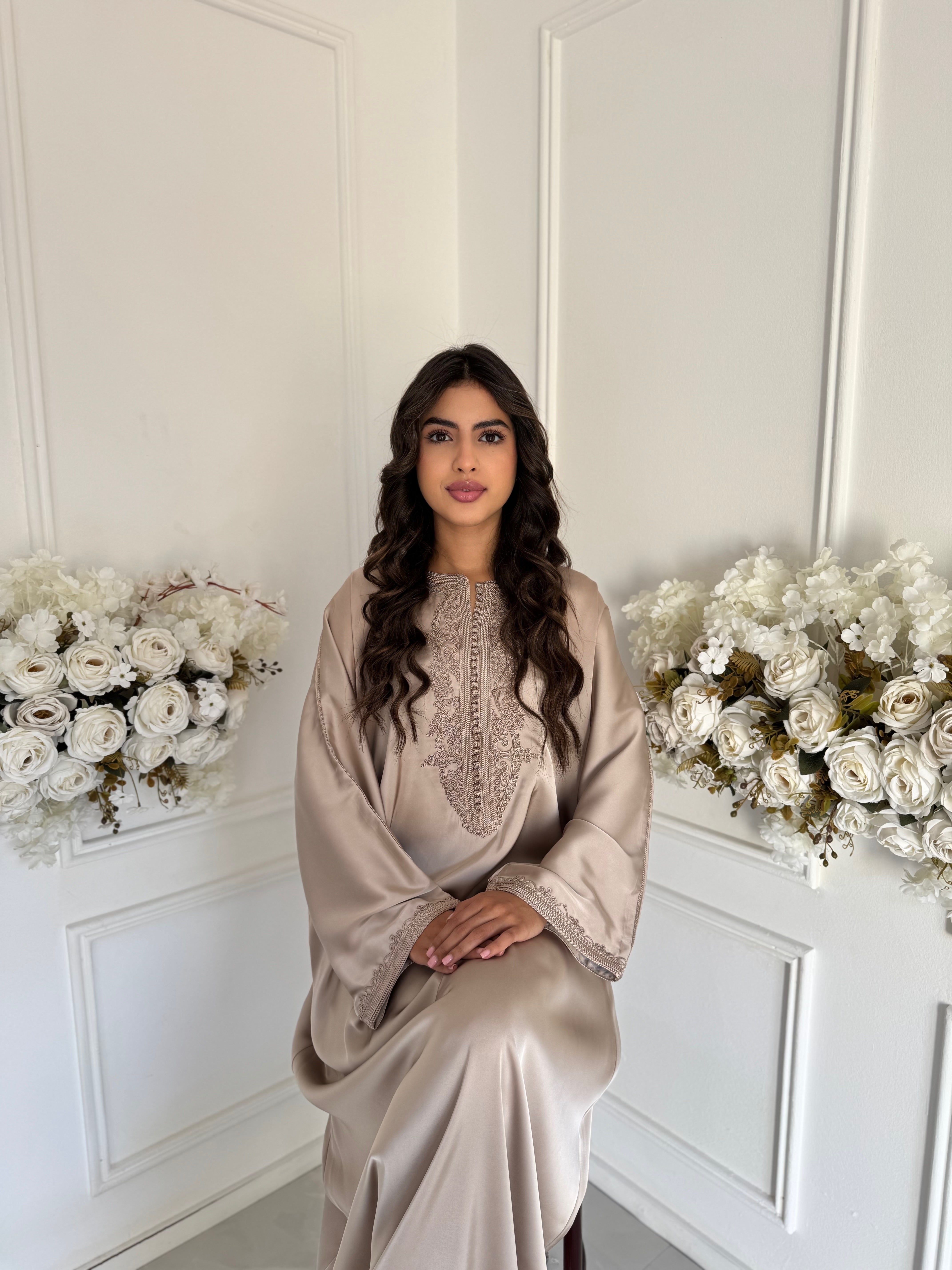 “Model wearing Gandoura Samra — champagne beige Moroccan gandoura in silky drap de soie fabric.”