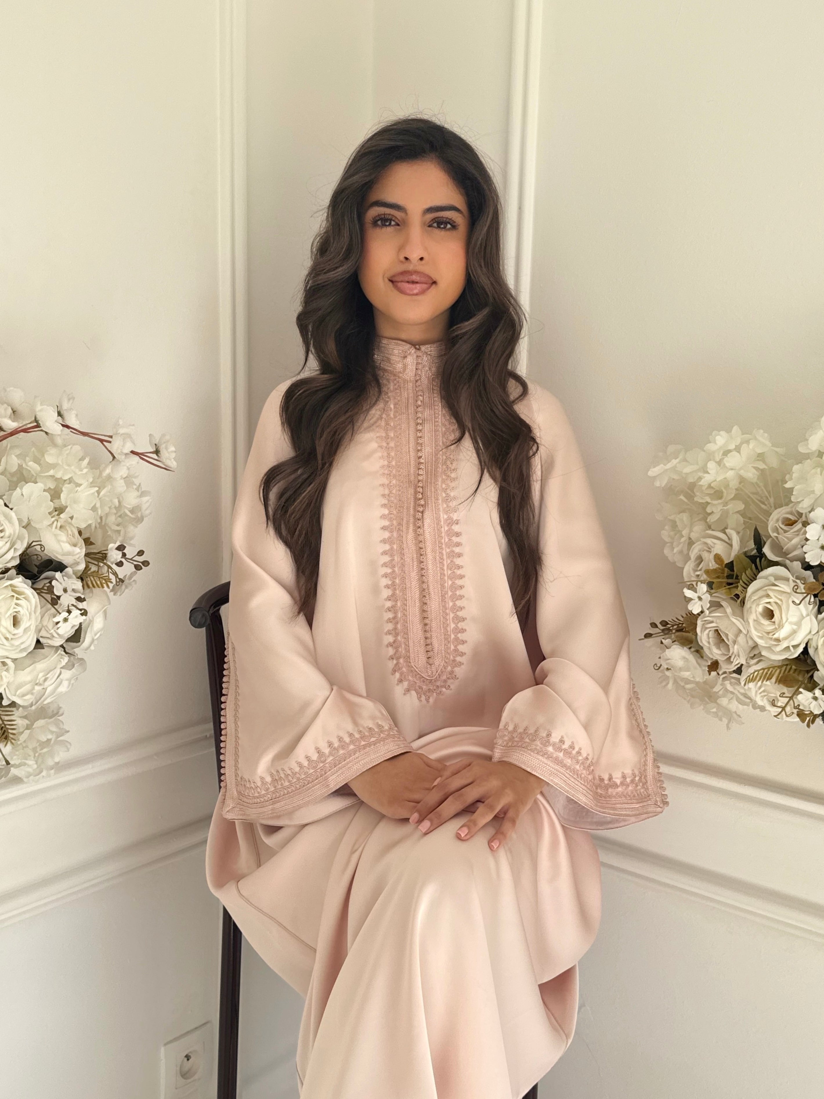 Model wearing Gandoura Farah – blush pink Moroccan dress with subtle embroidery