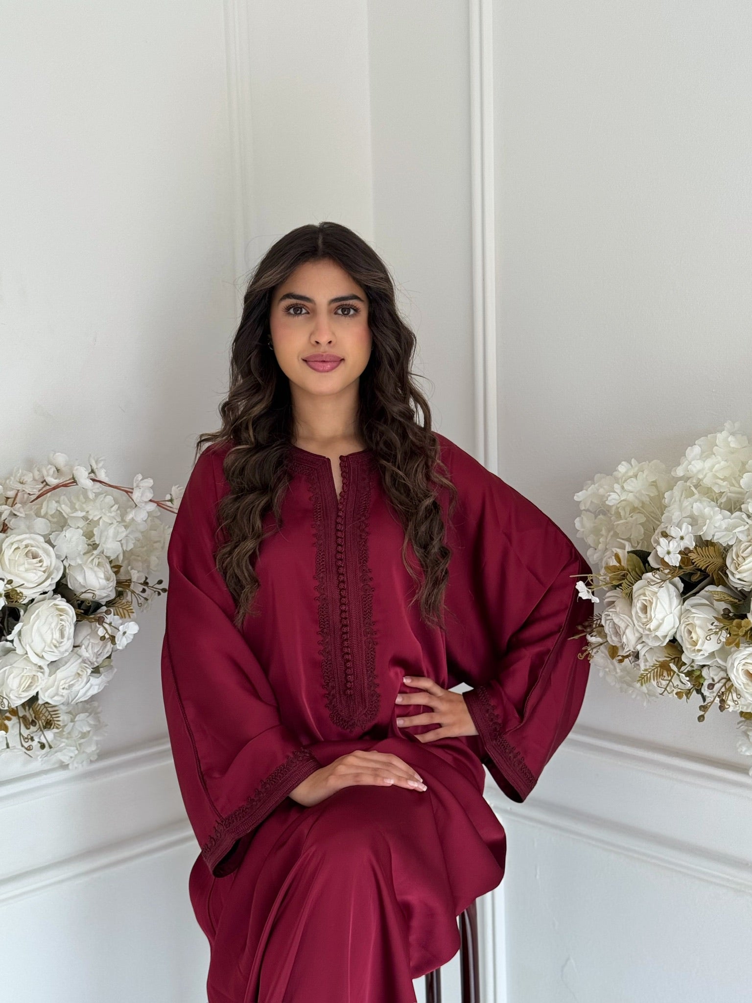 Model wearing the burgundy Gandoura Sonia Moroccan dress made from drap de soie