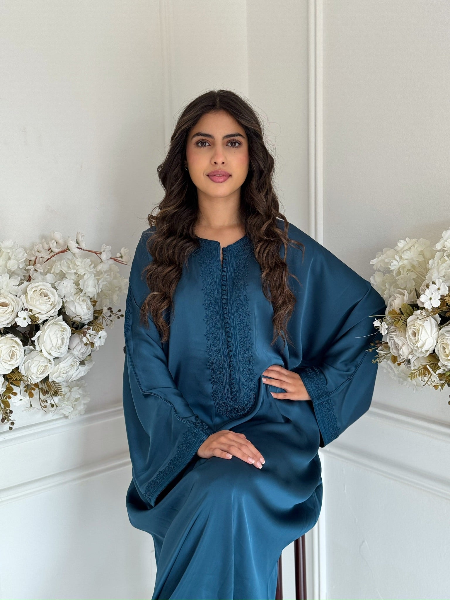 Model wearing the teal blue Gandoura Qamar Moroccan dress in drap de soie silk.