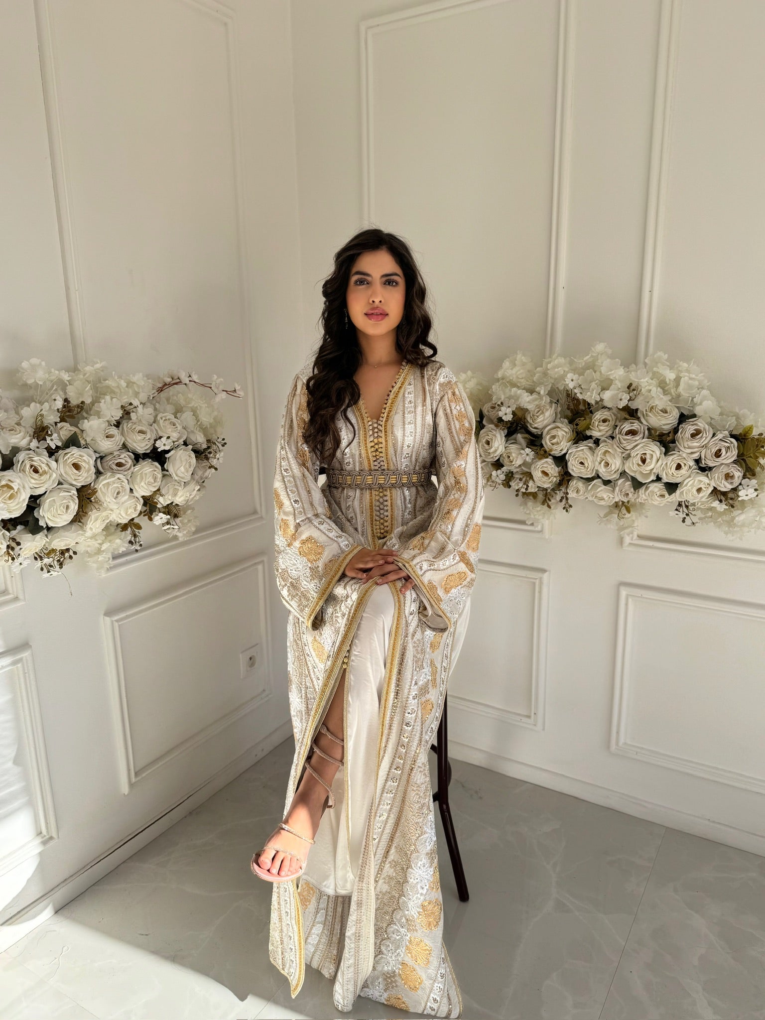 Close-up of embroidered golden details on Takchita Fadila organza fabric