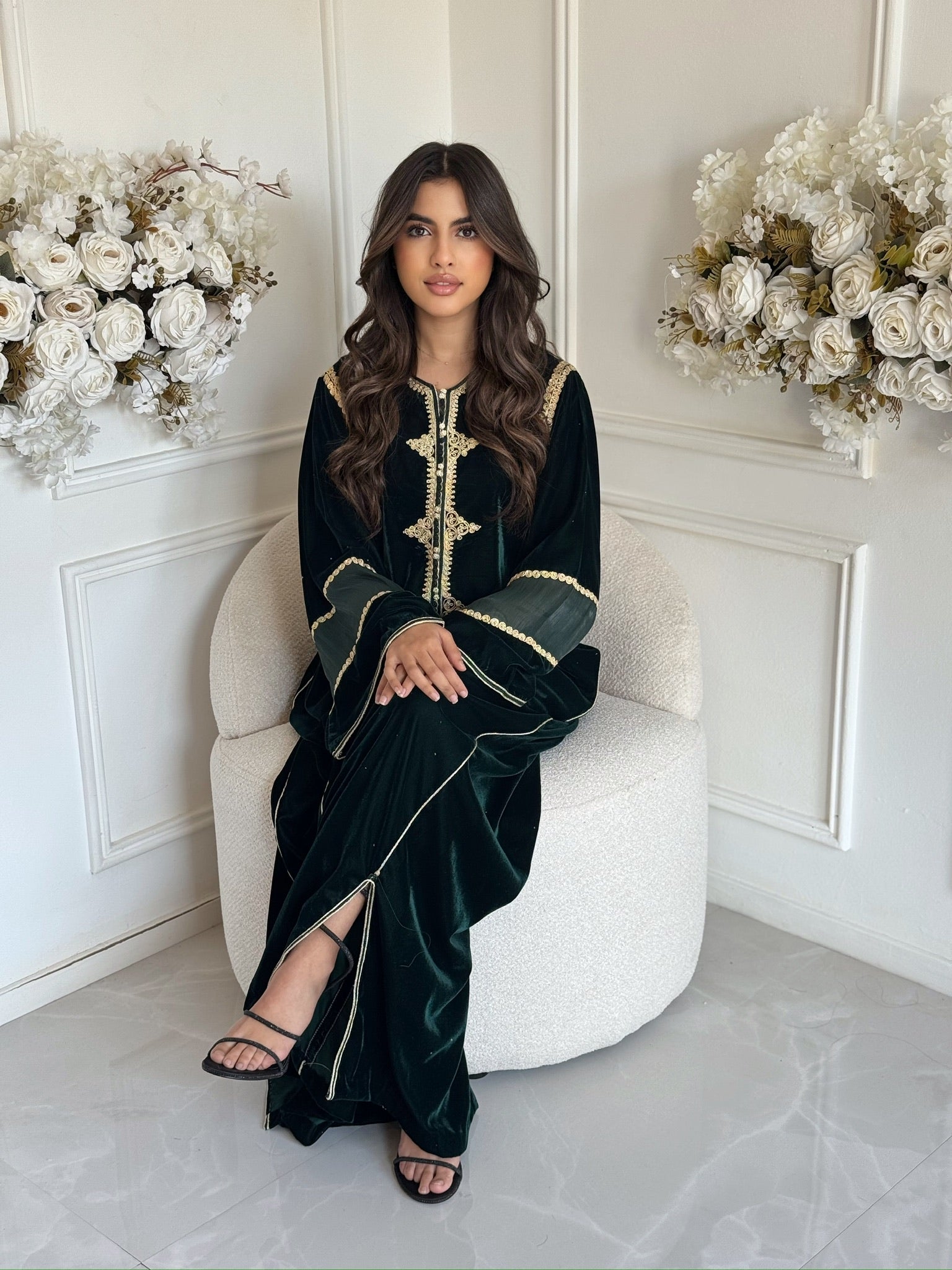 Full-body view of black and gold Moroccan gandoura with elegant details in a white interior