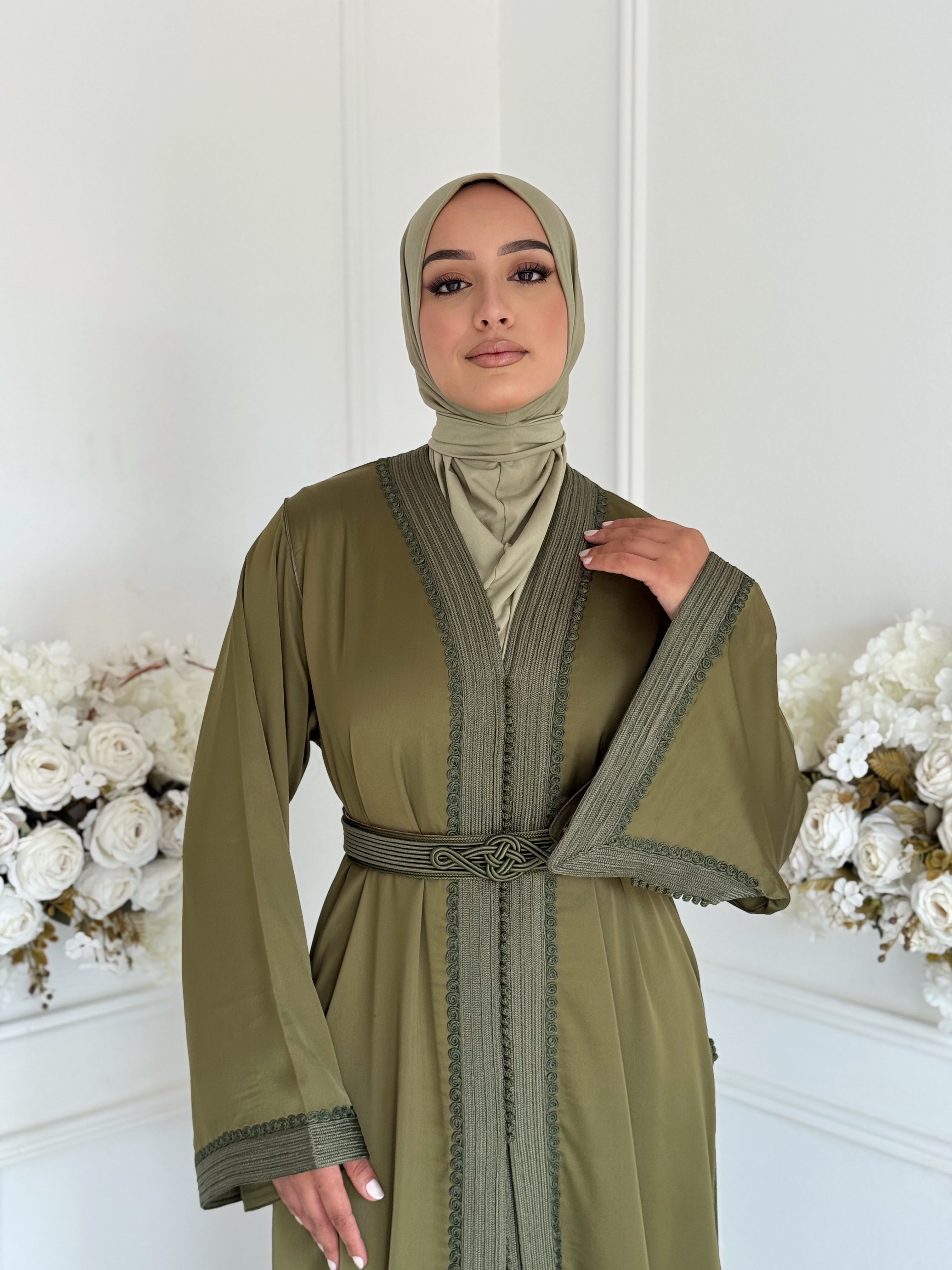 Model wearing Takchita Khaoula – elegant olive-green Moroccan takchita made from crepe fabric.