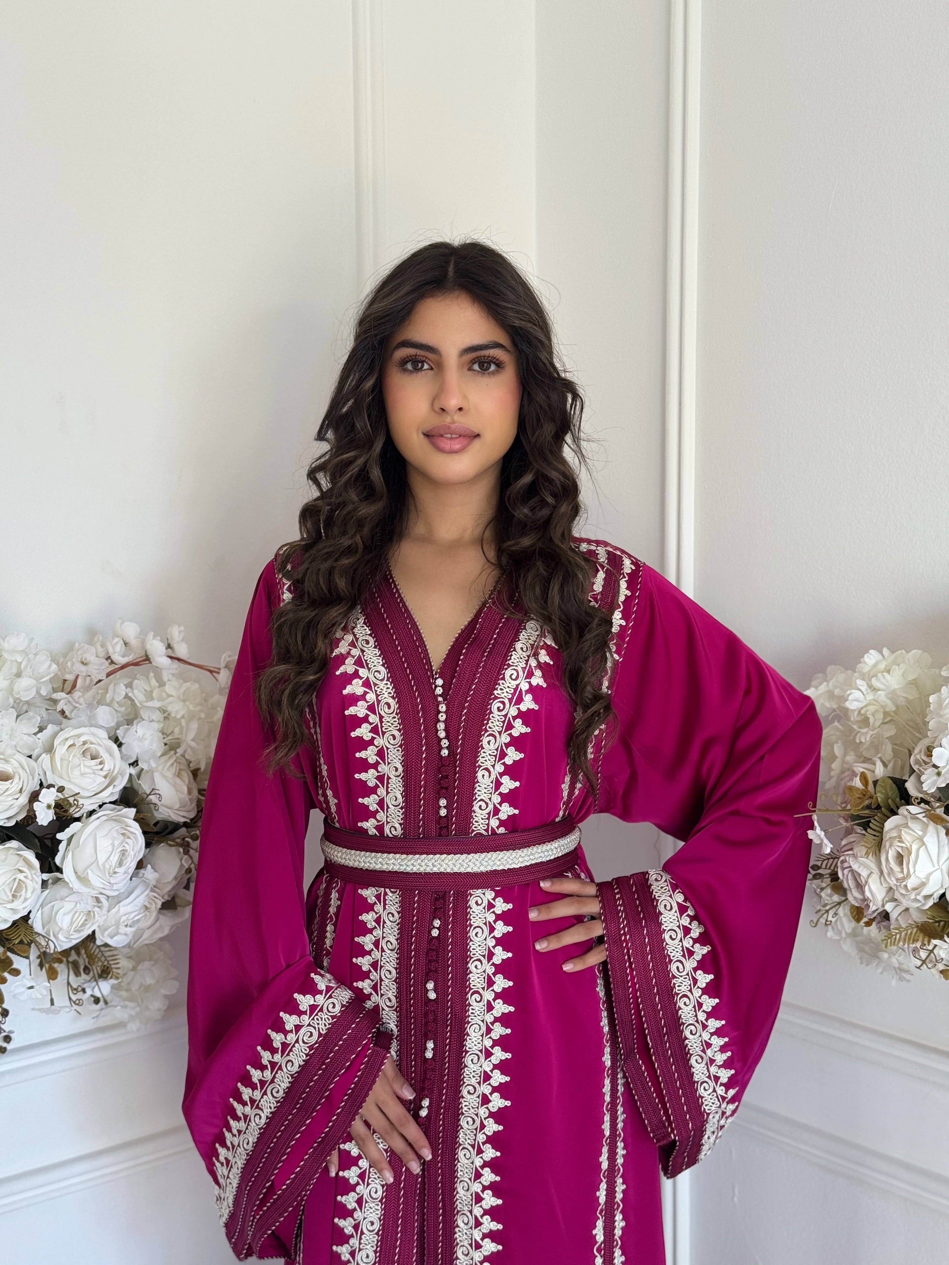 “Model wearing Takchita Nabila — magenta Moroccan takchita with handmade embroidery, crafted from high-quality fabric.”
