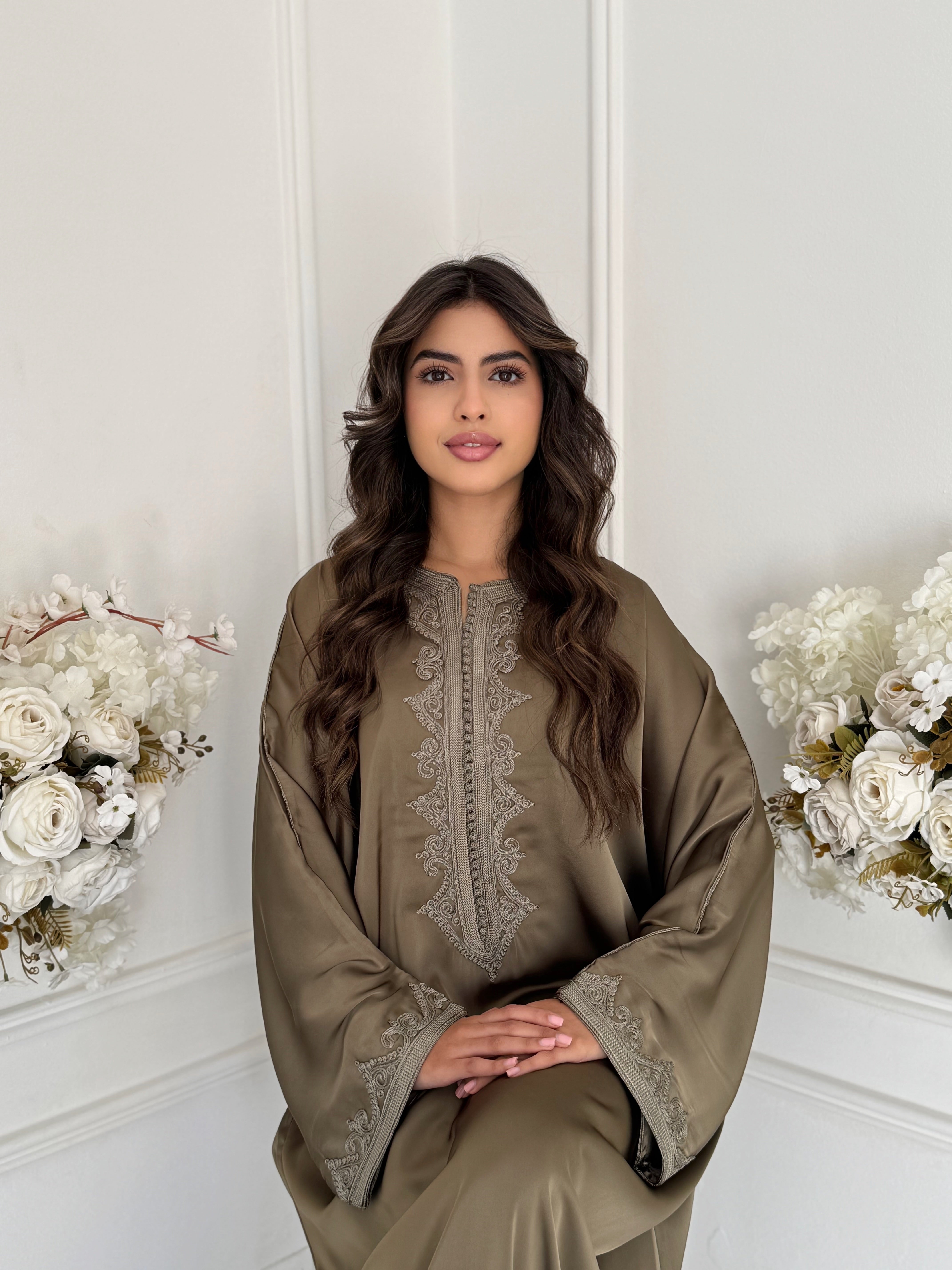 “Model wearing Gandoura Saria – elegant silky Moroccan Gandoura in olive tone, made from drap de soie fabric.”