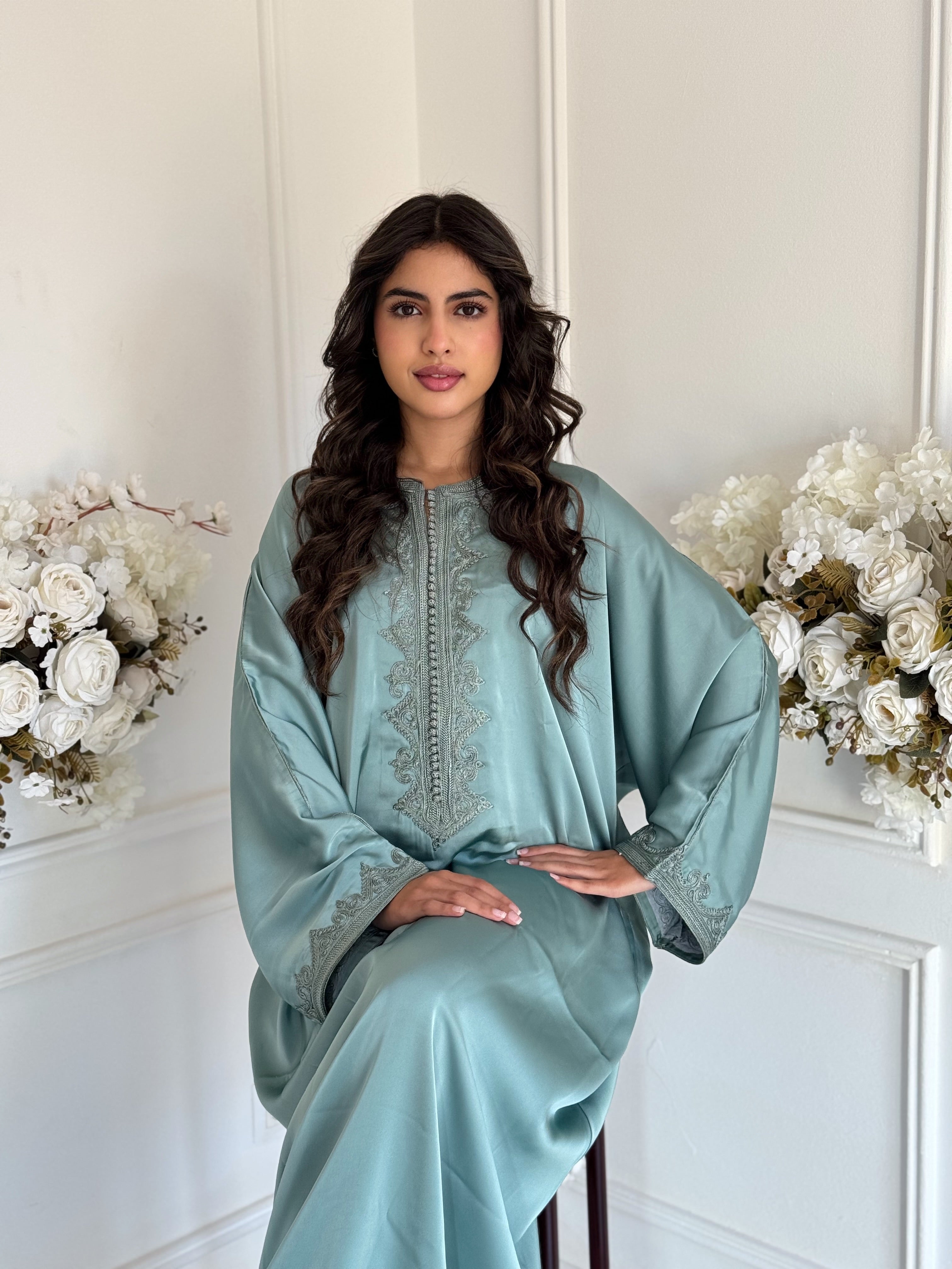 “Model wearing Gandoura Reem – elegant silky Moroccan Gandoura in light mint tone, made from drap de soie fabric.”