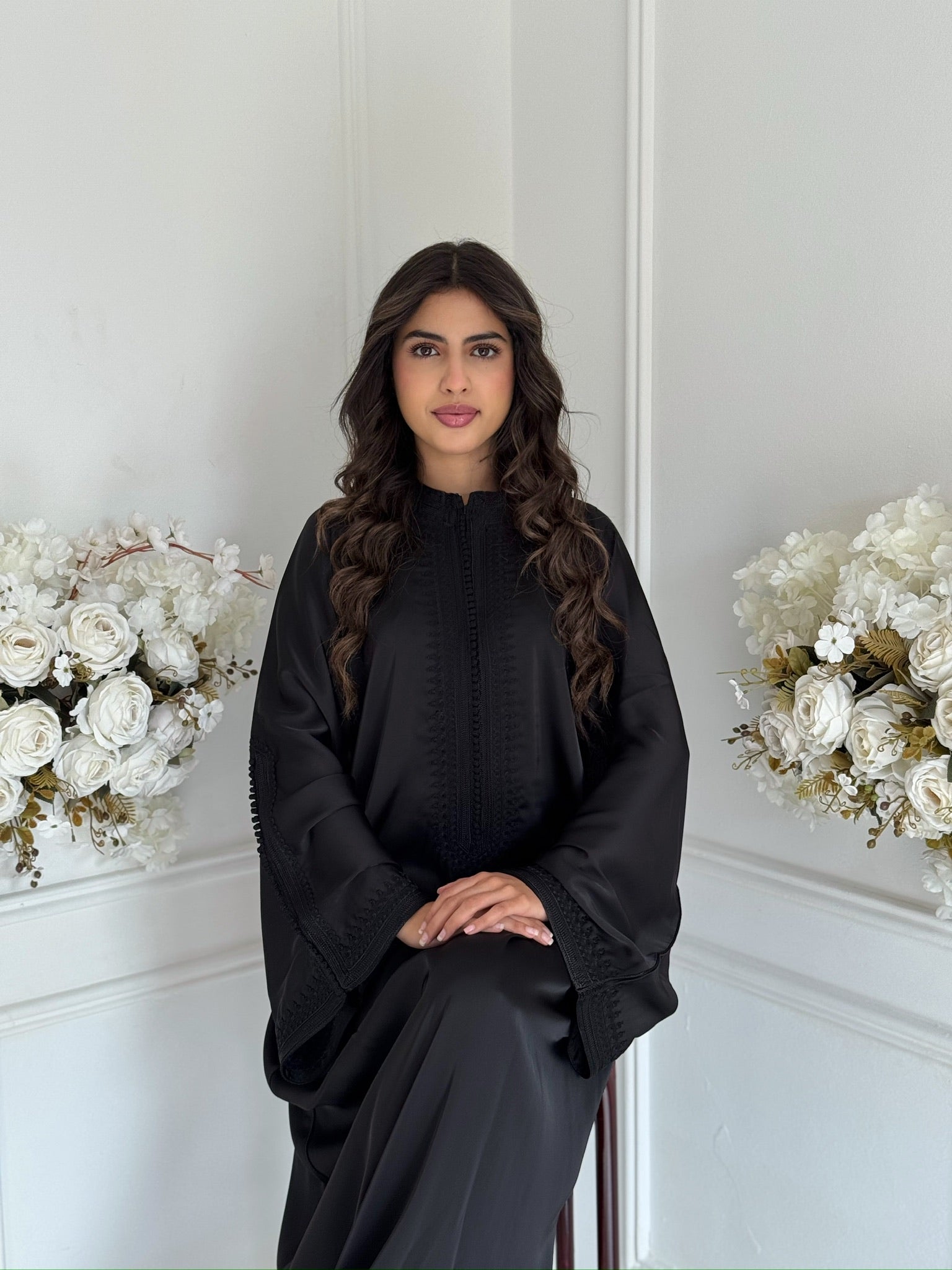 Model wearing the black Gandoura Mina Moroccan dress in drap de soie silk