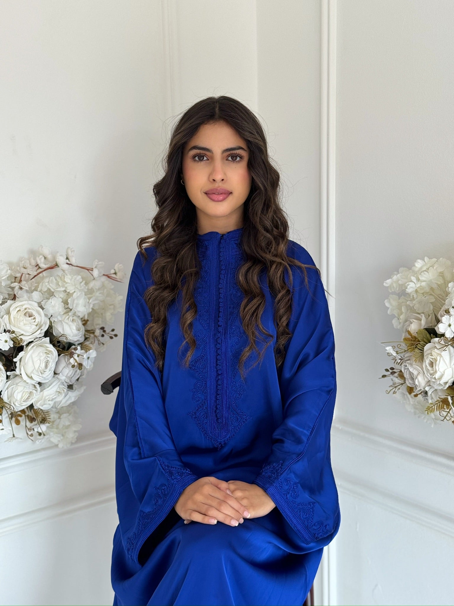 Close-up of Gandoura Niama embroidery showing Arabic craftsmanship.
