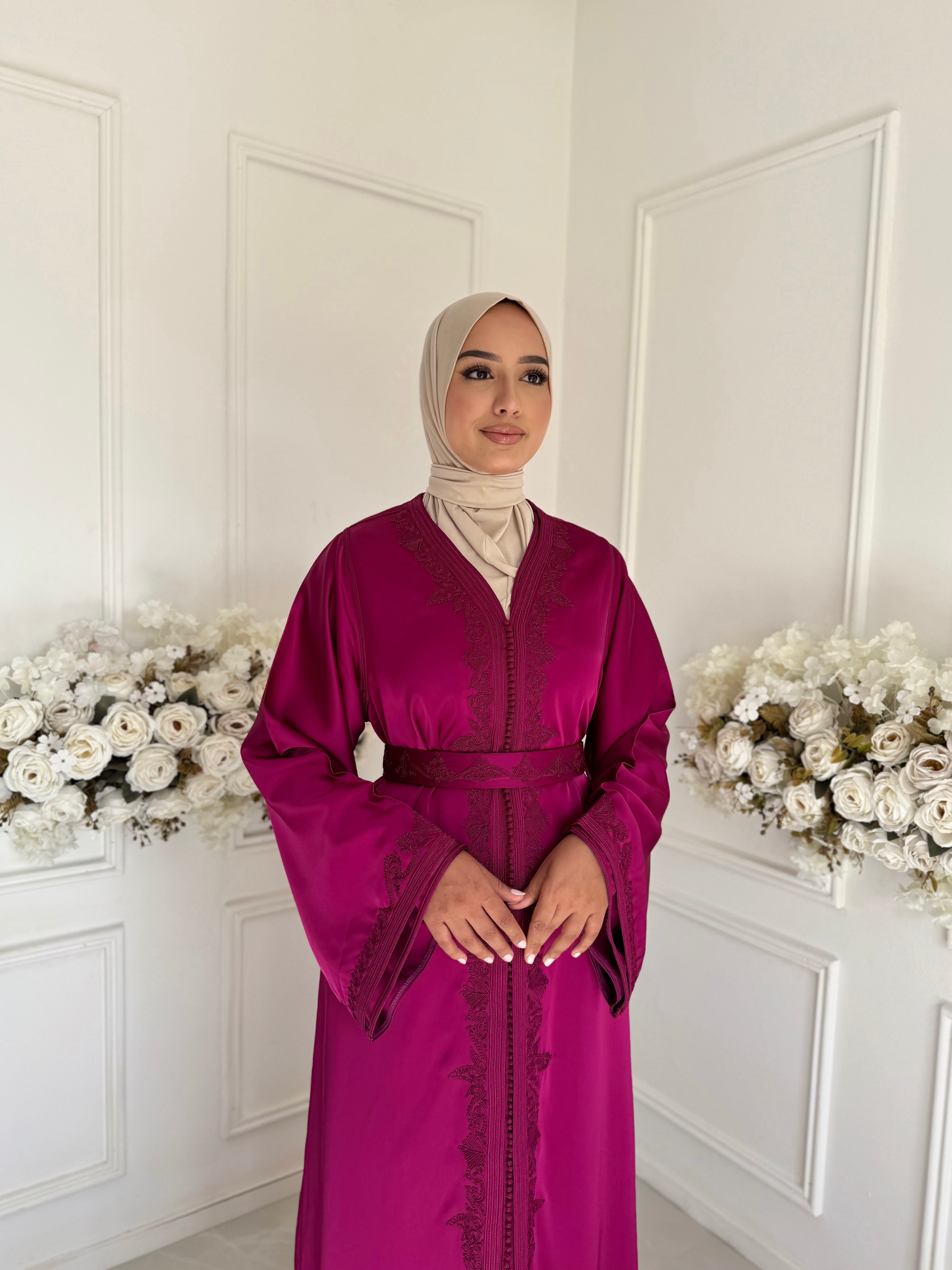 Model wearing Takchita Coco – fuchsia Moroccan takchita made from luxurious drap de soie fabric.”